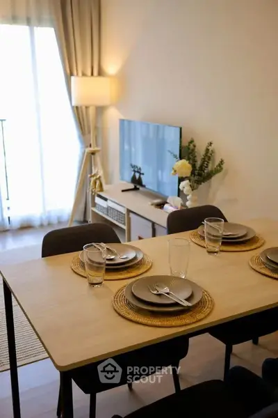Modern living room with dining area and natural light