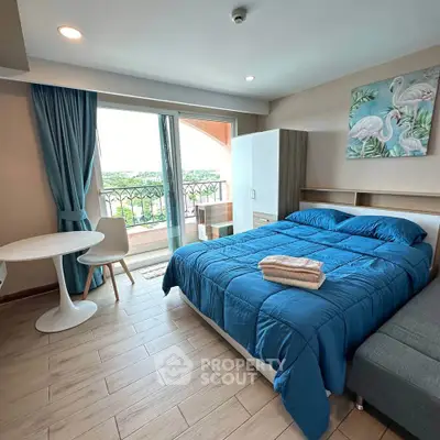 Charming bedroom with balcony access and scenic view, featuring modern decor and cozy ambiance.