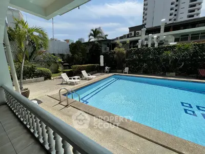Luxurious residential pool area with lush greenery and modern design