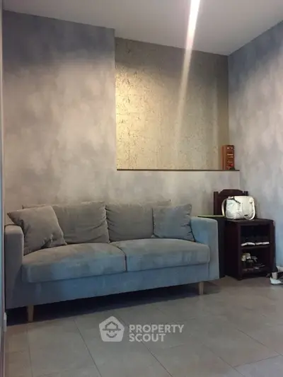 Cozy living room with modern gray sofa and stylish decor
