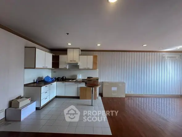 Spacious open-layout kitchen with modern cabinets and ample natural light