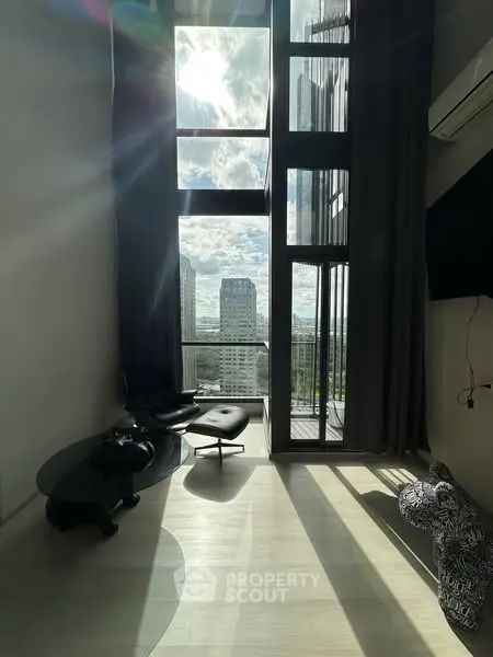 Stunning high-rise apartment with floor-to-ceiling windows and breathtaking city view.