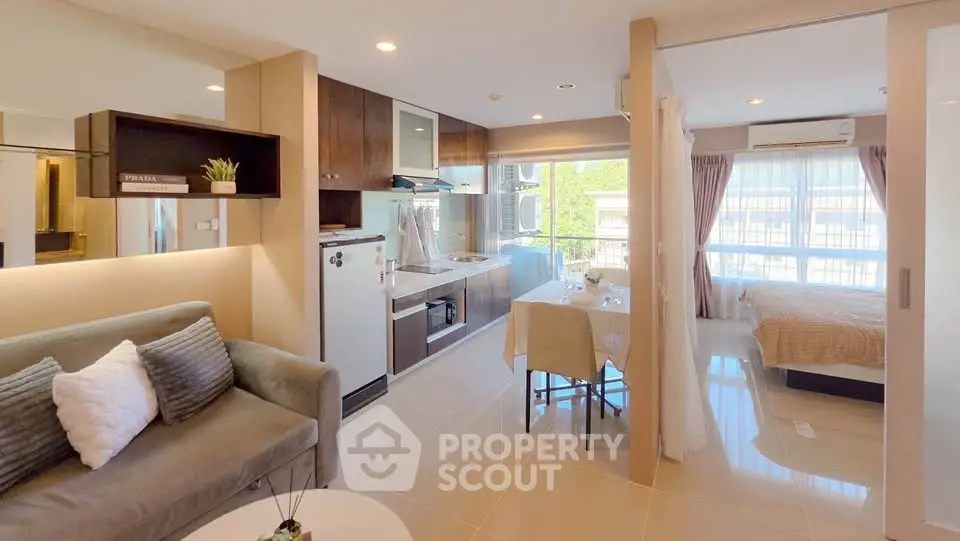 Modern open-plan apartment with stylish living area, kitchen, and cozy bedroom, featuring large windows and natural light.