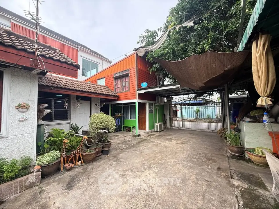 Charming residential property with spacious driveway and lush greenery, perfect for family living.