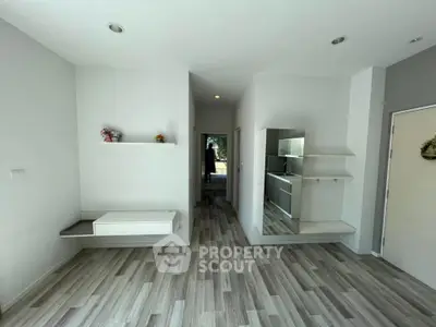 Modern minimalist interior with sleek flooring and built-in shelves, perfect for stylish living.
