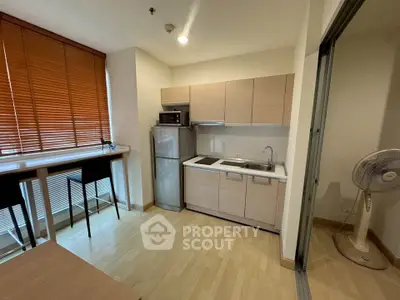 Modern kitchen with sleek cabinets and breakfast bar in cozy apartment