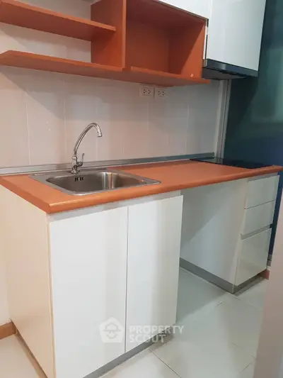 Modern kitchen with sleek cabinetry and stainless steel sink