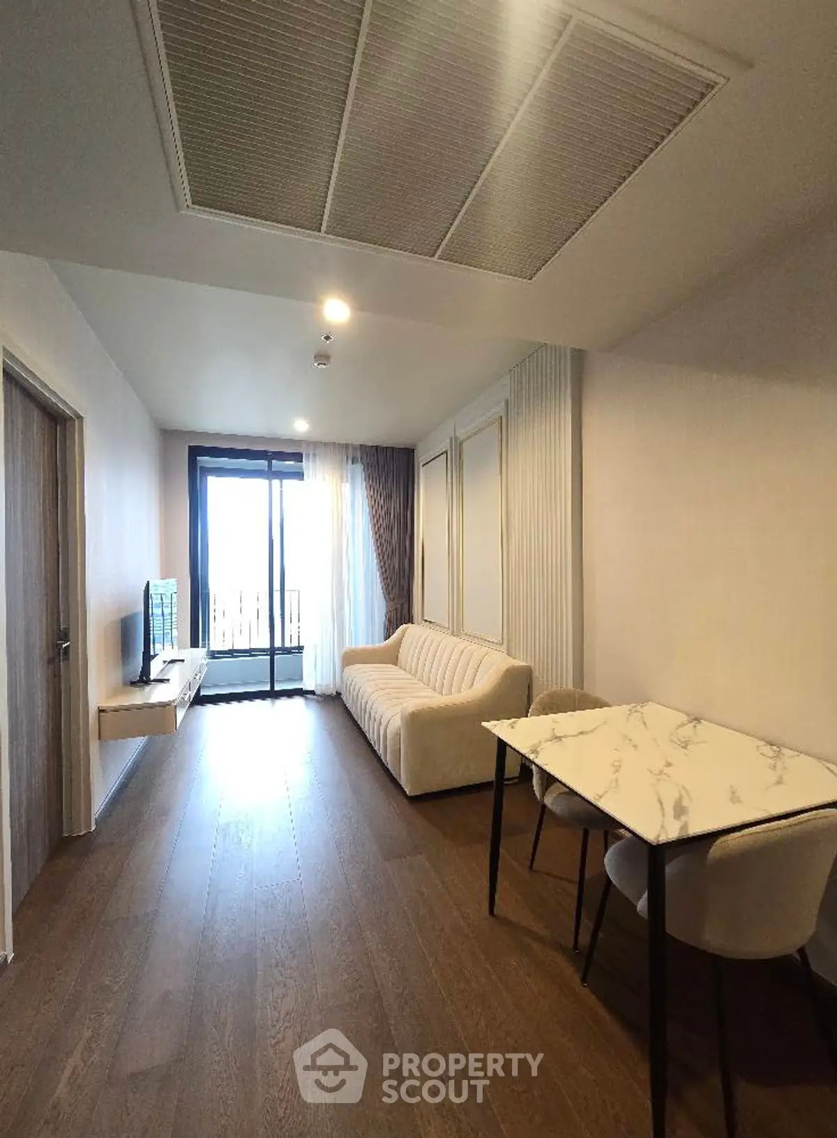 Modern living room with sleek furniture and large window for natural light.