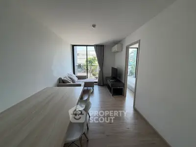 Modern living room with natural light and sleek furniture in a contemporary apartment.