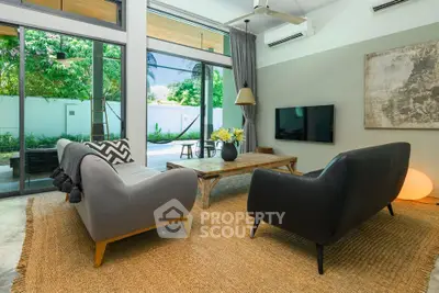 Spacious living room with modern furniture and garden view, perfect for relaxation and entertainment.