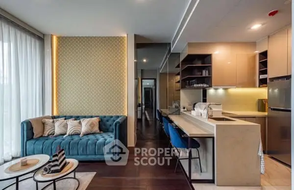 Modern open-plan living room and kitchen with stylish decor and natural light.