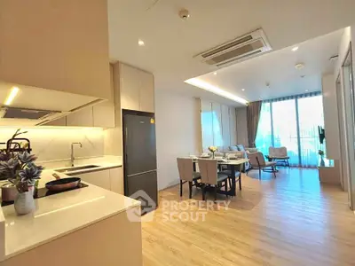 Spacious open-plan kitchen and living area with modern furnishings and natural light.