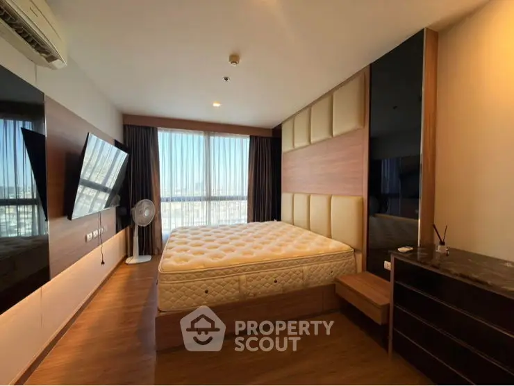 Spacious bedroom with modern design and ample natural light