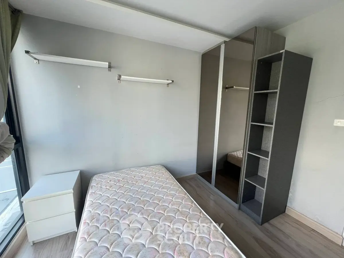 Minimalist bedroom with mattress and built-in wardrobe, perfect for urban living.