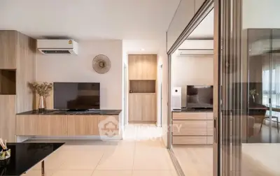 Modern living room with sleek design and large TV, featuring stylish wooden accents.