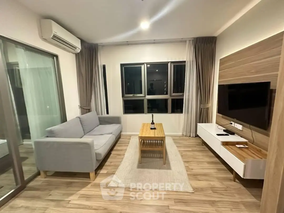 Modern living room with sleek furniture and large windows in a stylish apartment.