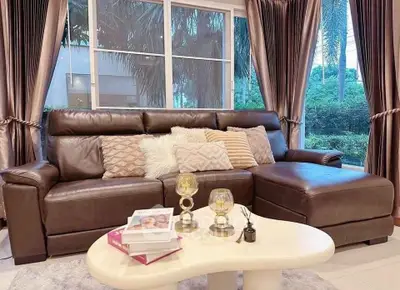 Luxurious living room with elegant leather sofa and stylish decor, perfect for relaxation and entertaining.