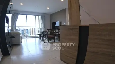 Spacious living room with modern furniture and large windows offering natural light.