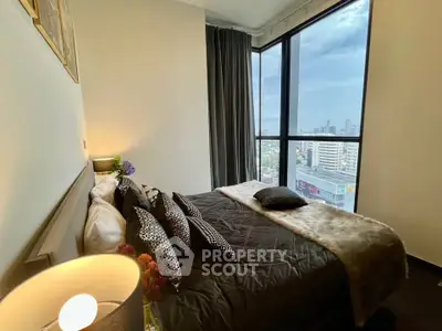 Luxurious bedroom with stunning city view and elegant decor in high-rise apartment.