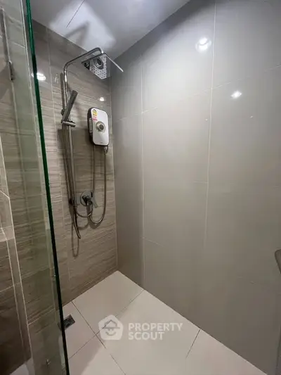 Modern bathroom with sleek shower design and neutral tiles