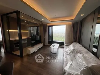 Modern living room with large windows and city view, featuring sleek furniture and ambient lighting.