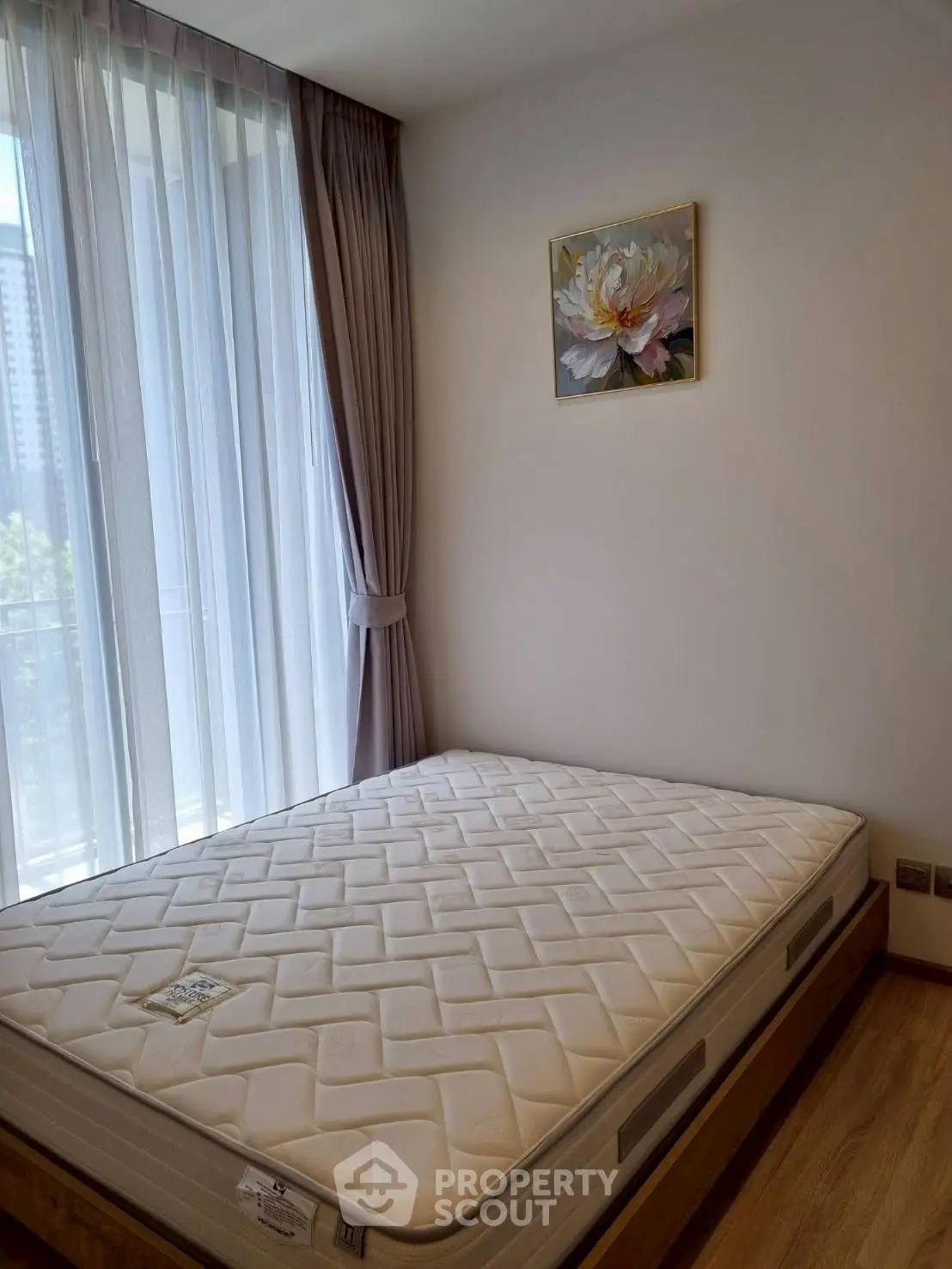 Bright bedroom with large window and modern decor in a stylish apartment.