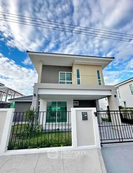 Modern two-story house with sleek design and spacious front yard
