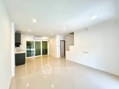 Spacious modern living room with sleek tile flooring and ample natural light.
