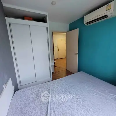 Cozy bedroom with air conditioning and modern wardrobe in a stylish apartment.