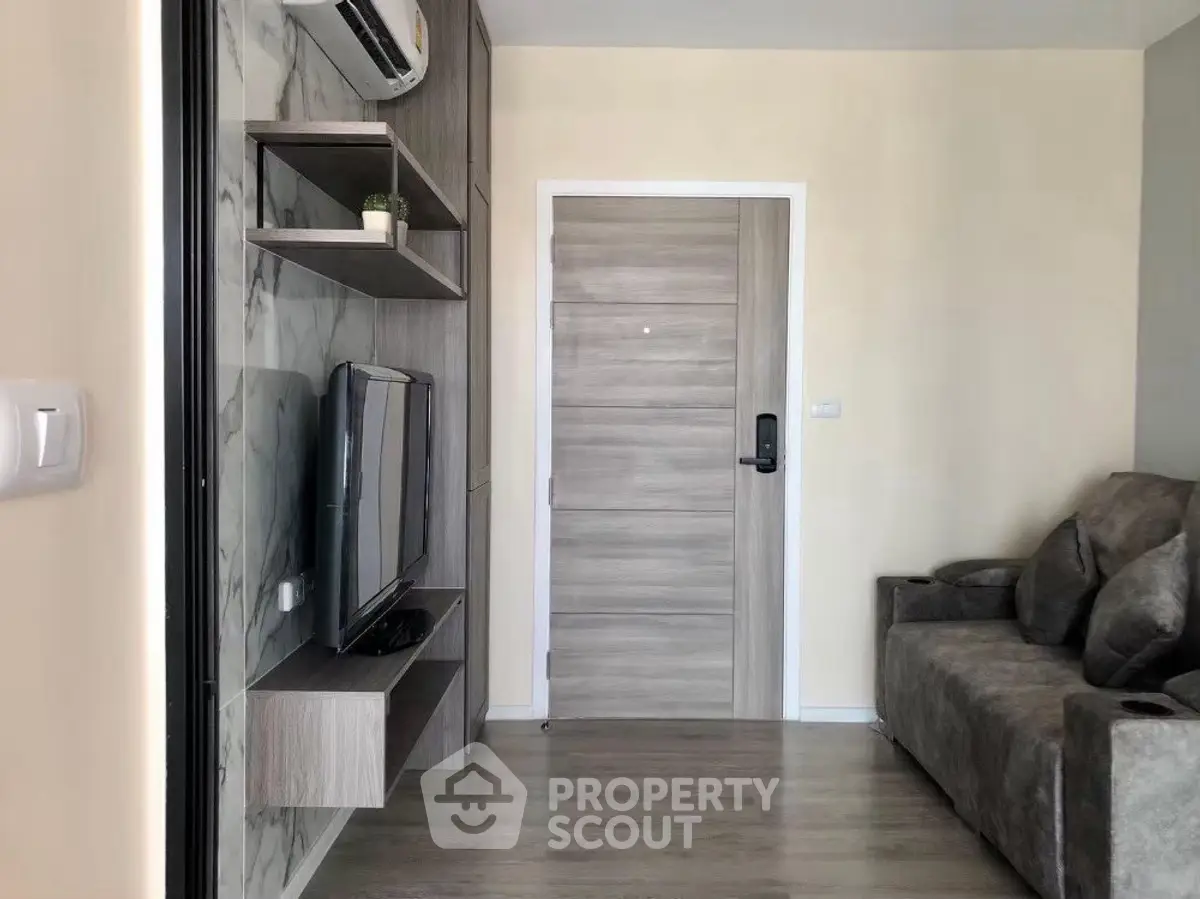 Modern living room with sleek TV setup and cozy seating