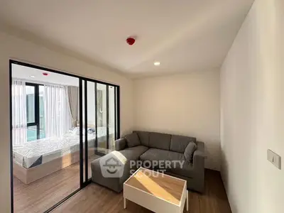 Modern living room with cozy gray sofa and natural light