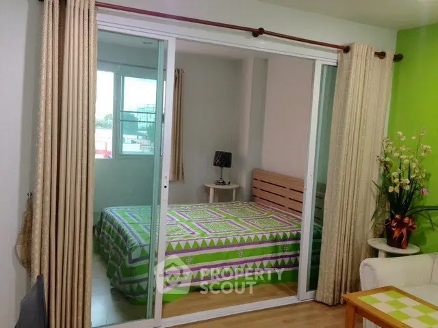 Cozy bedroom with sliding glass doors and vibrant green accents