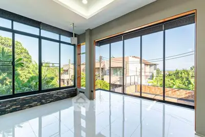 Spacious corner unit with floor-to-ceiling windows and stunning garden views.