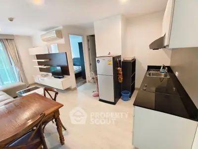 Modern open-plan living room and kitchen with sleek design and natural light.
