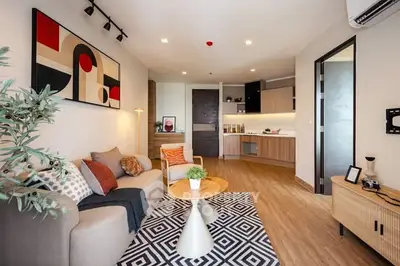 Modern living room with stylish decor and open kitchen layout.