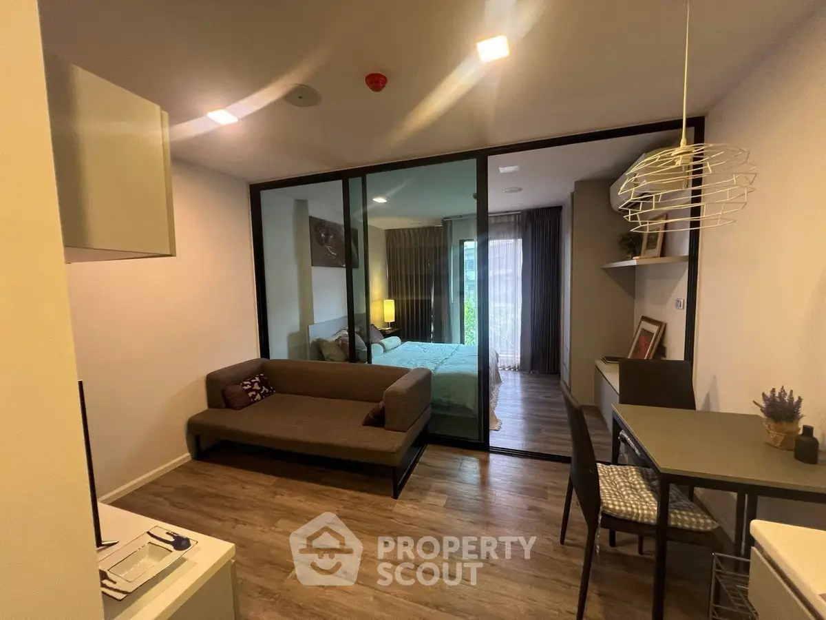 Modern studio apartment with glass partition and stylish furnishings