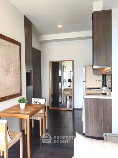 Chic modern kitchen with sleek cabinetry and cozy dining area, perfect for urban living.