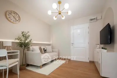 Modern living room with stylish decor and elegant lighting, featuring a cozy sofa and wall-mounted TV.