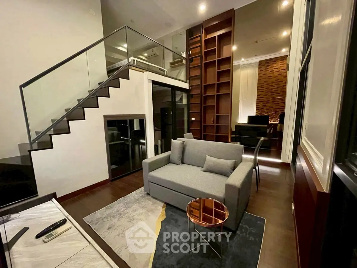 Modern duplex living room with stylish furniture and open staircase