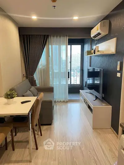 Modern living room with sleek furniture and city view balcony in a stylish apartment.