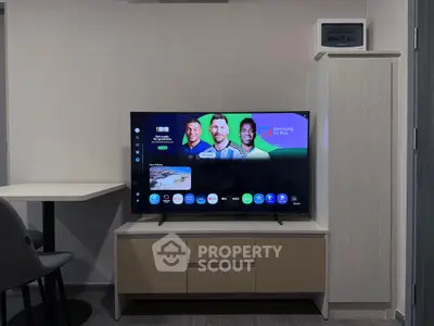 Modern living room with sleek TV setup and stylish furniture, perfect for entertainment and relaxation.