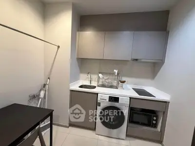 Modern compact kitchen with integrated appliances and sleek cabinetry