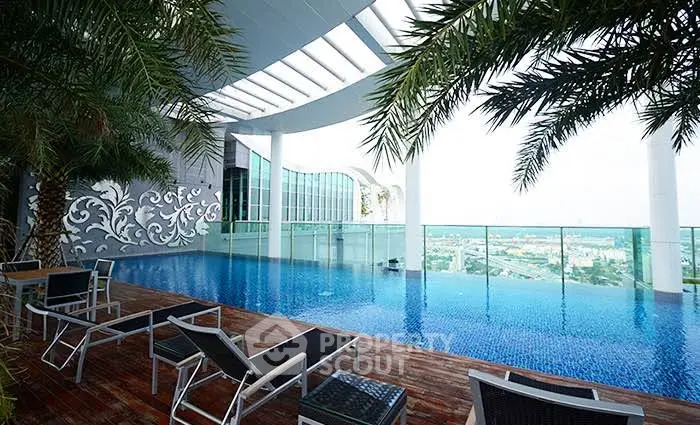 Luxurious rooftop pool with stunning city views and modern lounge chairs, perfect for relaxation.