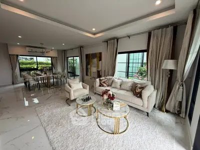 Luxurious living room with elegant decor and spacious dining area, perfect for entertaining.