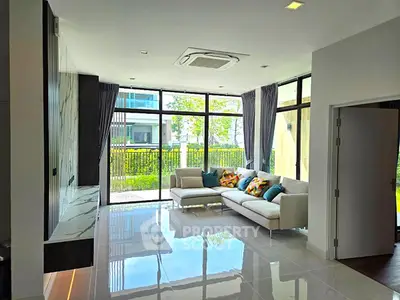 Spacious modern living room with large windows and stylish decor