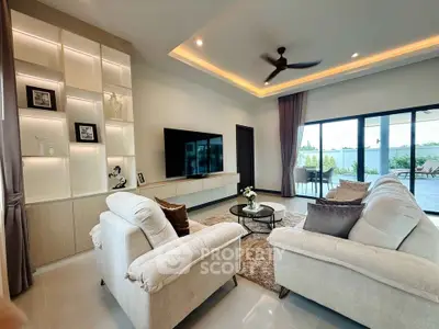 Luxurious living room with modern decor and large balcony view
