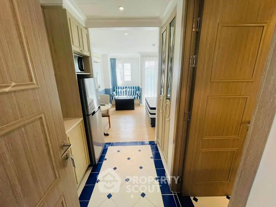 Charming apartment entrance leading to a cozy living room with stylish decor and natural light.