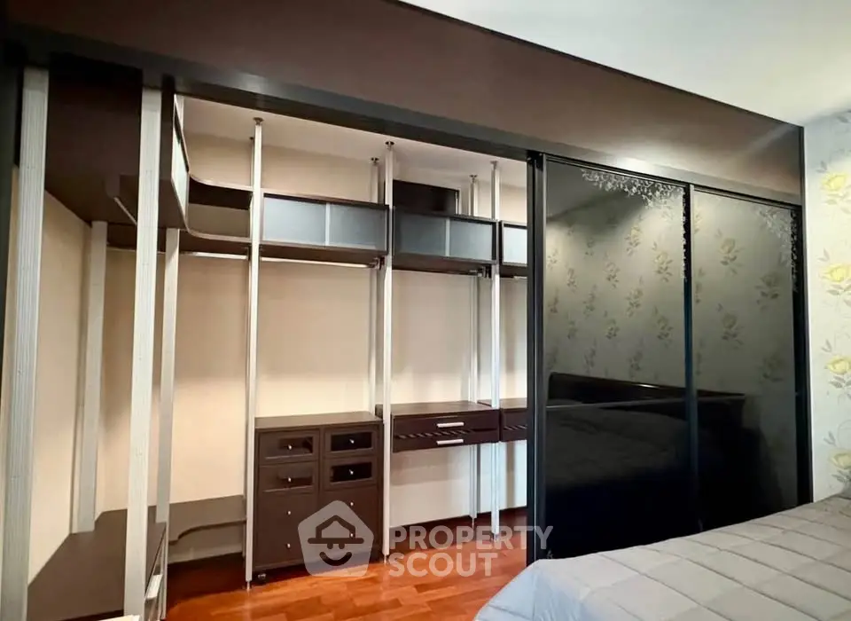Spacious bedroom with modern walk-in closet and elegant sliding doors