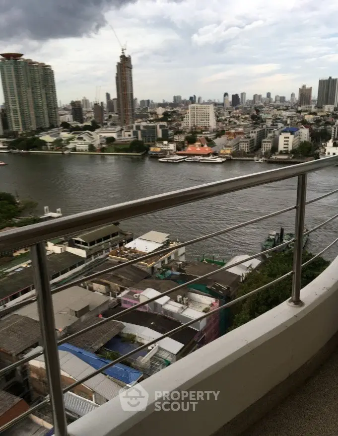 Stunning river view from a high-rise balcony in a bustling cityscape.