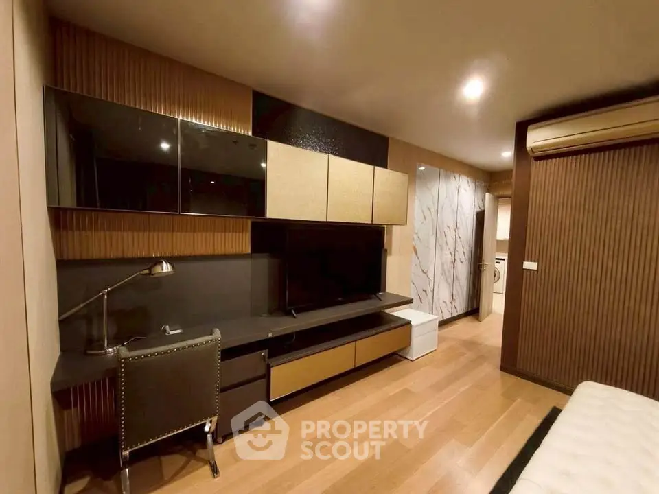 Modern living room with sleek design, featuring built-in storage and stylish decor.